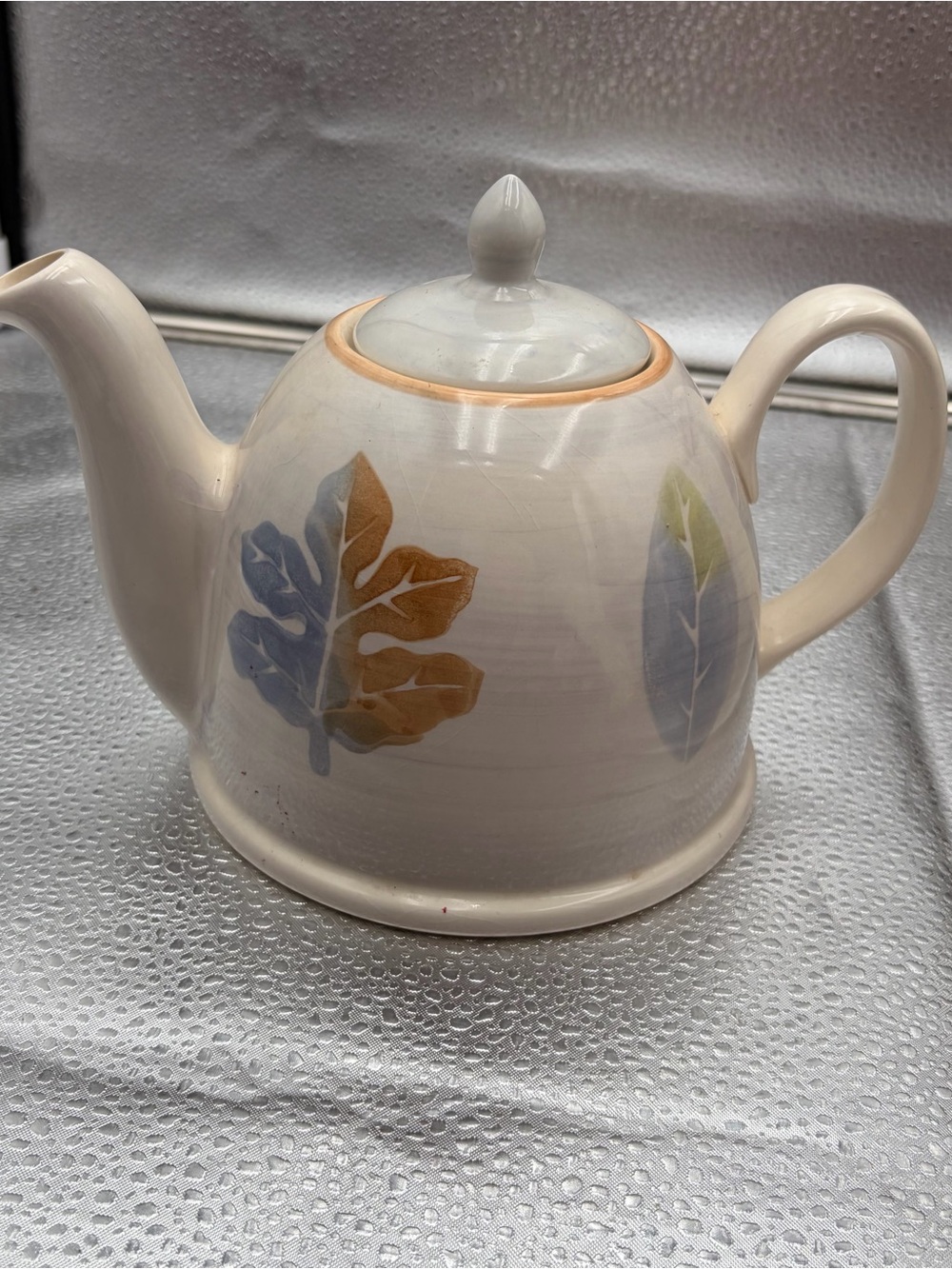 Leaf-Accent Ceramic Teapot in Cream with Blue and Brown Leaves